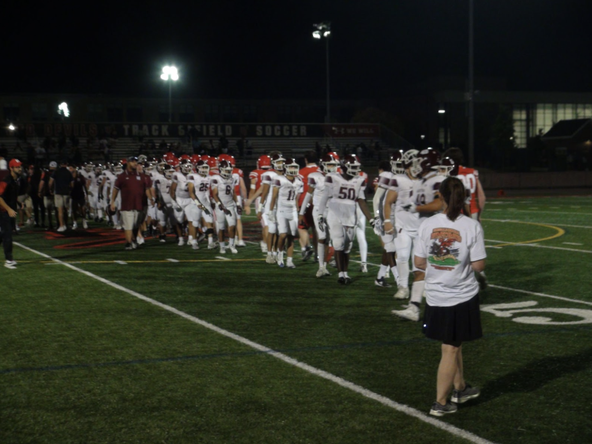 Both teams meet in the middle of the field to tell each other that they respect the other team. 